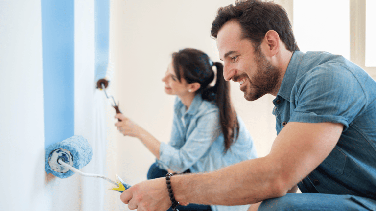 A man and woman painting.