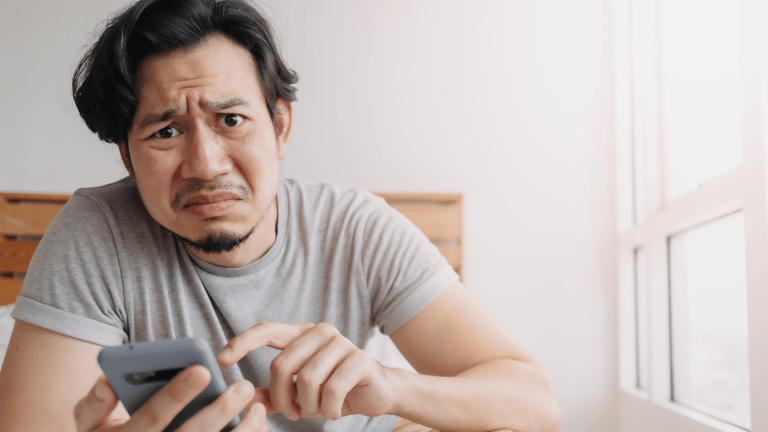 A distressed man with a smartphone.